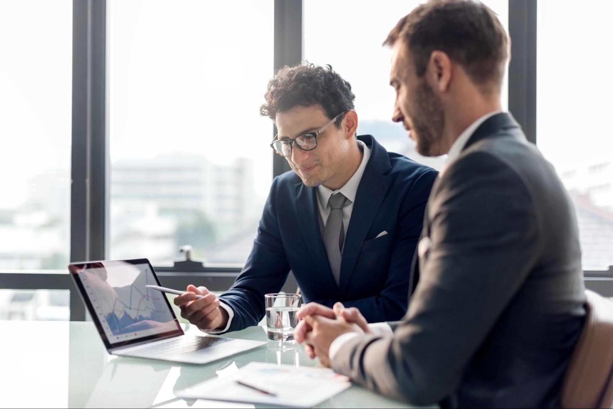 two businessmen talking about data