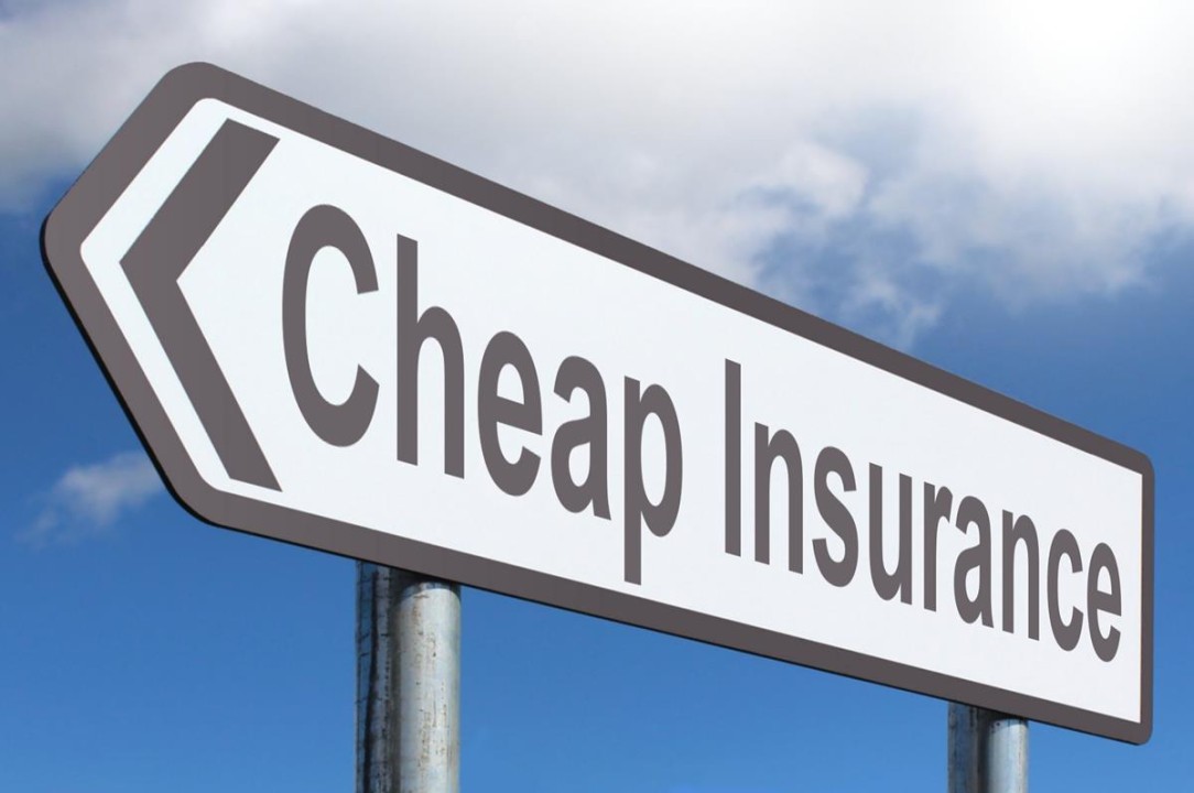cheap insurance written on a road sign